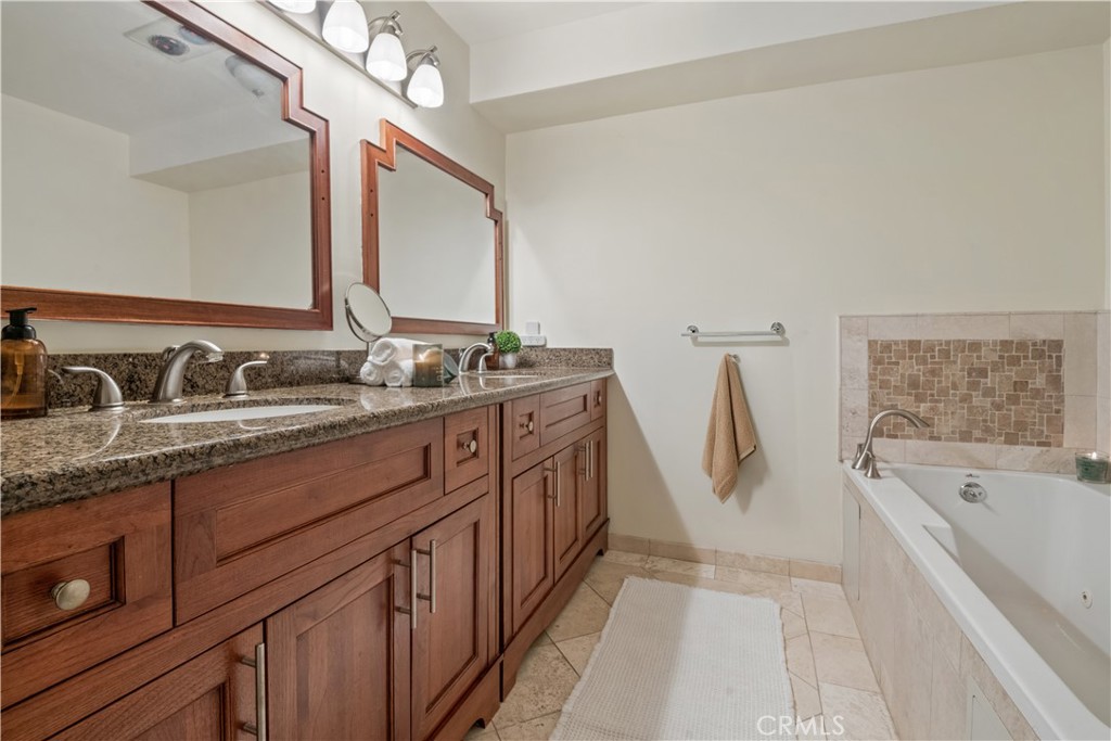 6221 Monterey Road, Unit 304 Highland Park, CA 90042 - Photo 20 of 27 a spacious bathroom with a double vanity sink a mirror and a bathtub