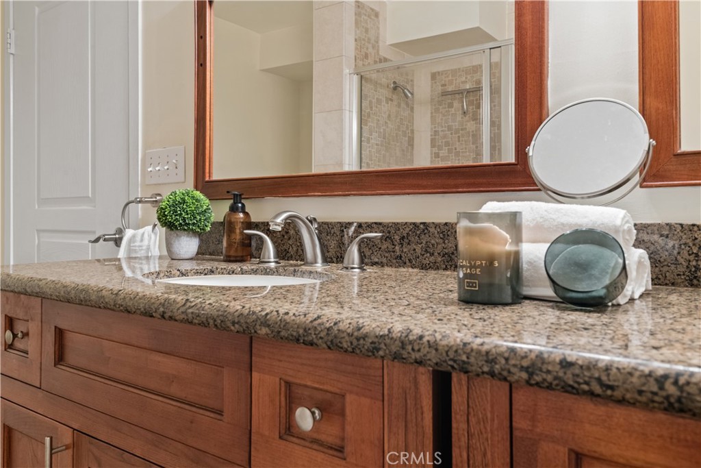 6221 Monterey Road, Unit 304 Highland Park, CA 90042 - Photo 21 of 27 a bathroom with a granite countertop double vanity sink and mirror