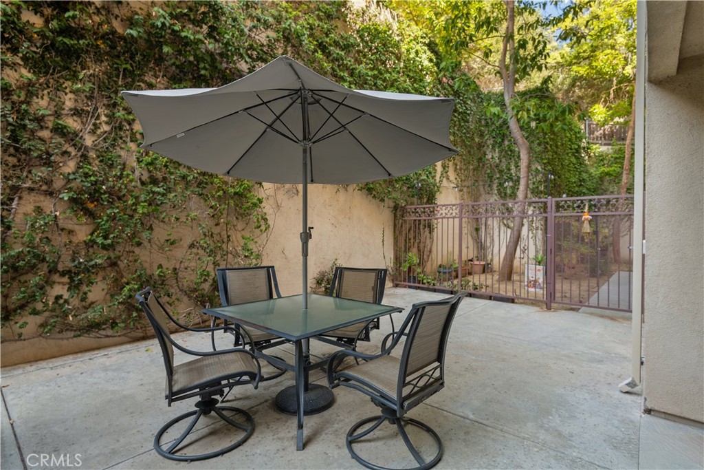 6221 Monterey Road, Unit 304 Highland Park, CA 90042 - Photo 23 of 27 a view of patio with furniture and table under an umbrella