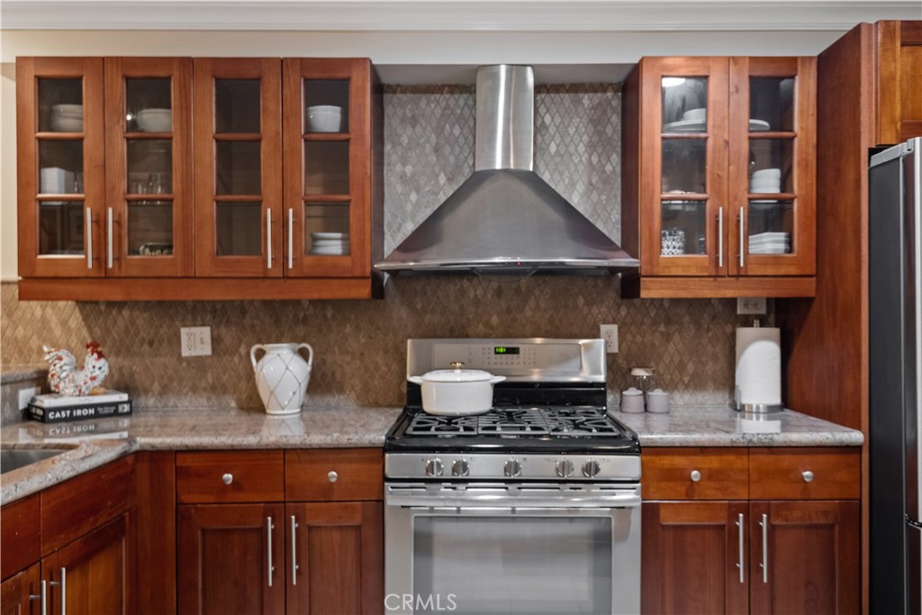 6221 Monterey Road, Unit 304 Highland Park, CA 90042 - Photo 8 of 27 a kitchen with stainless steel appliances granite countertop a stove and a white cabinets
