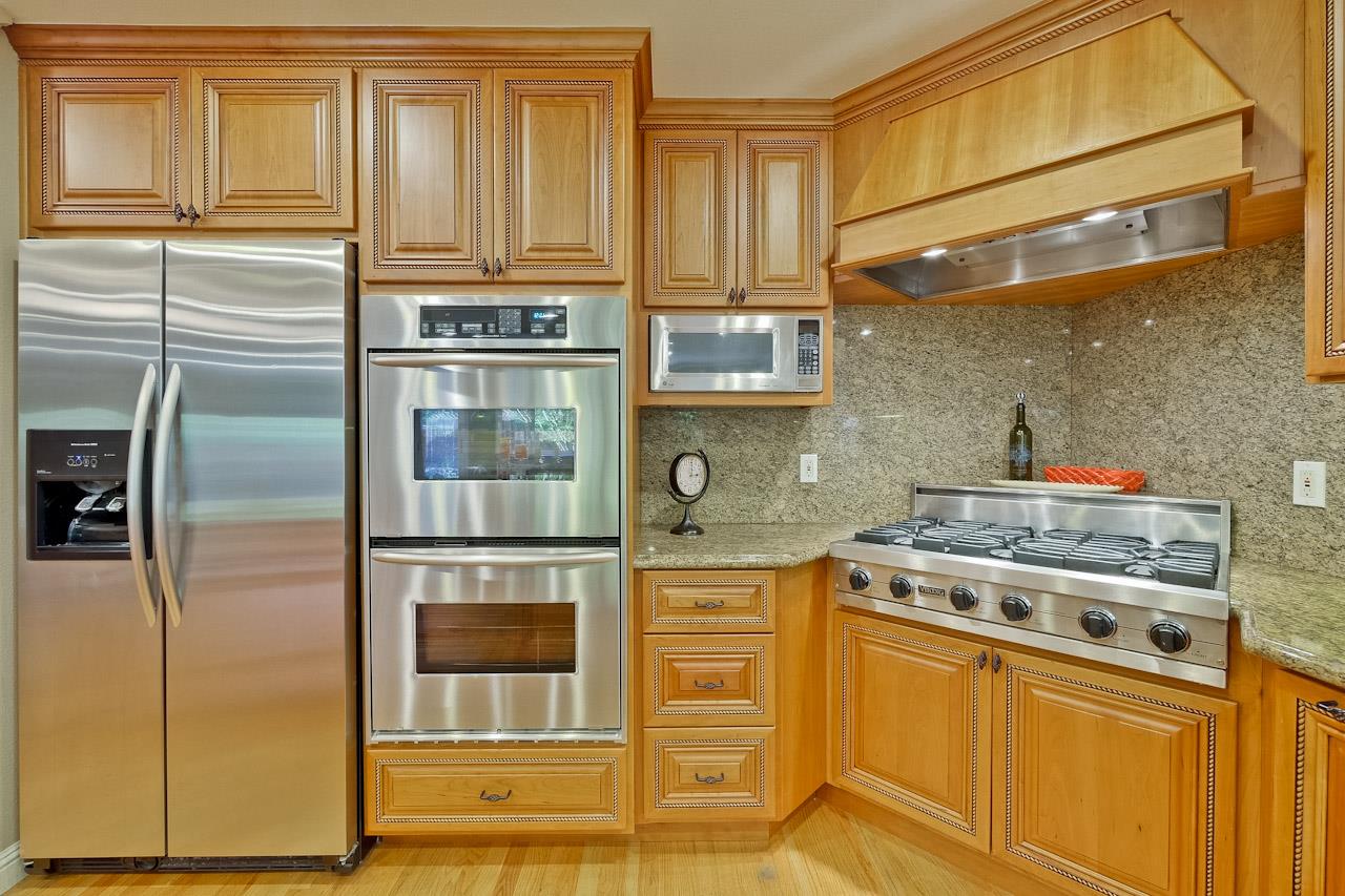1229 Rousseau Drive Sunnyvale, CA 94087 - Photo 13 of 37 a kitchen with stainless steel appliances granite countertop a stove and a refrigerator