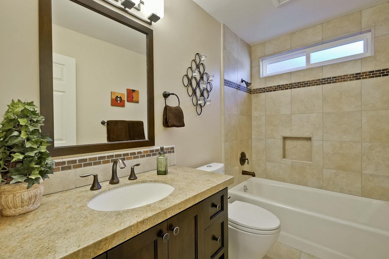 1229 Rousseau Drive Sunnyvale, CA 94087 - Photo 21 of 37 a bathroom with a granite countertop sink a toilet and shower