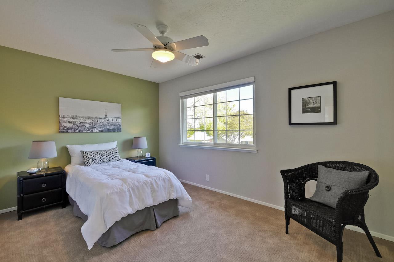 1229 Rousseau Drive Sunnyvale, CA 94087 - Photo 29 of 37 a bedroom with a bed and a chandelier