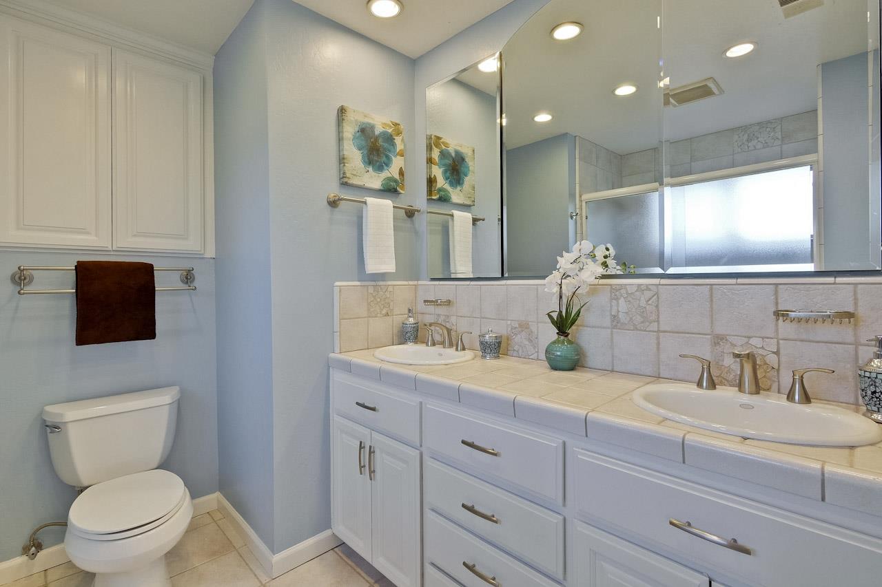 1229 Rousseau Drive Sunnyvale, CA 94087 - Photo 34 of 37 a bathroom with a toilet a sink and mirror