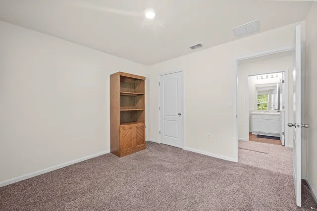 a bedroom with a bed and a television