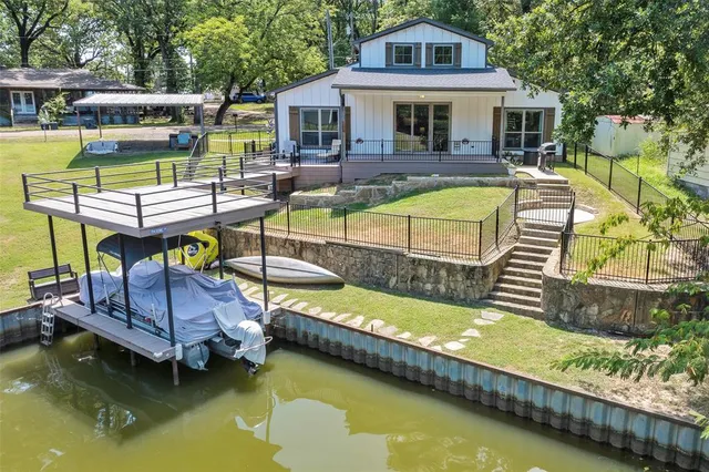 a view of an house with swimming pool and chairs