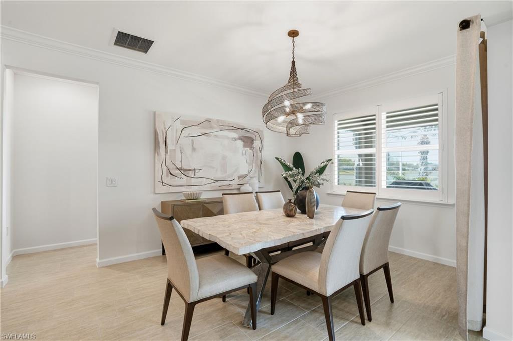 10520 Tidewater Key Boulevard Estero, FL 33928 - Photo 12 of 50 a view of a dining room with furniture window and wooden floor