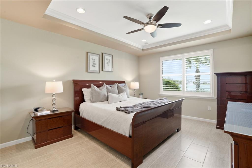 10520 Tidewater Key Boulevard Estero, FL 33928 - Photo 16 of 50 a spacious bedroom with a bed and window