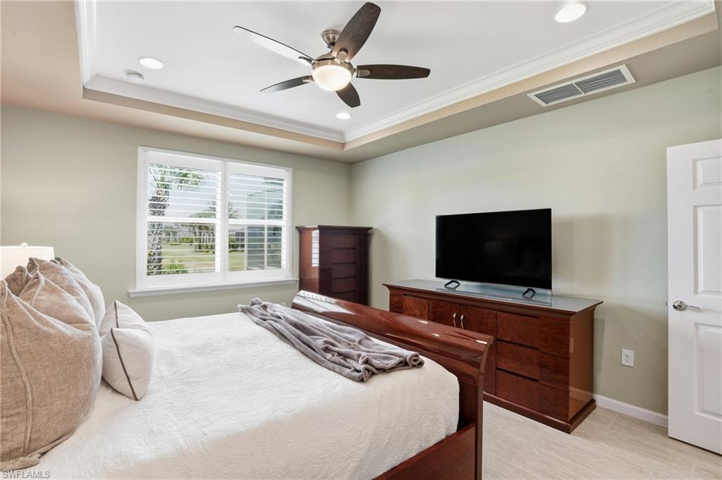 10520 Tidewater Key Boulevard Estero, FL 33928 - Photo 17 of 50 a bedroom with a bed and a flat screen tv