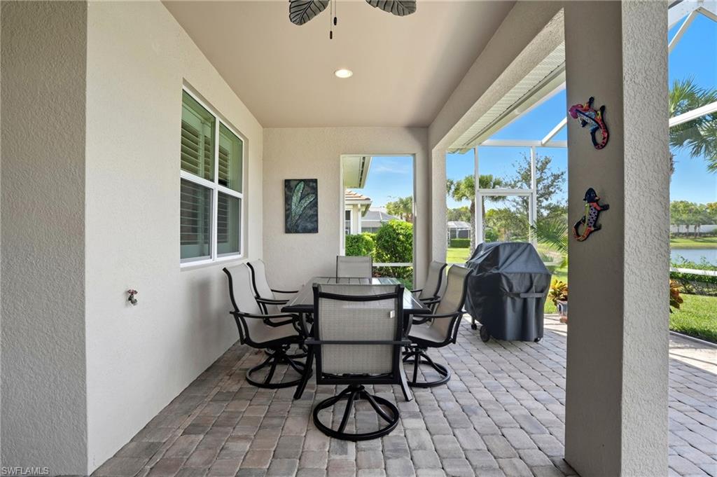 10520 Tidewater Key Boulevard Estero, FL 33928 - Photo 29 of 50 a dining room with wooden floor and floor to ceiling windows