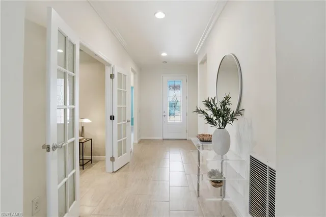 a view of a hallway with furniture and a entryway