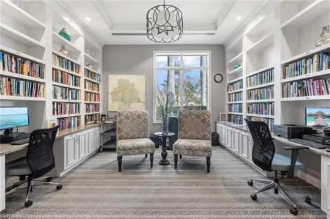a view of a livingroom with workspace and a window