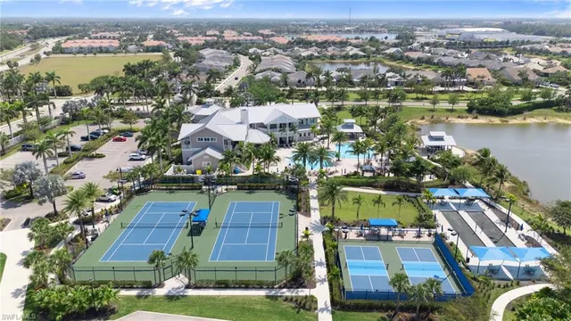 an aerial view of residential houses with outdoor space and lake view