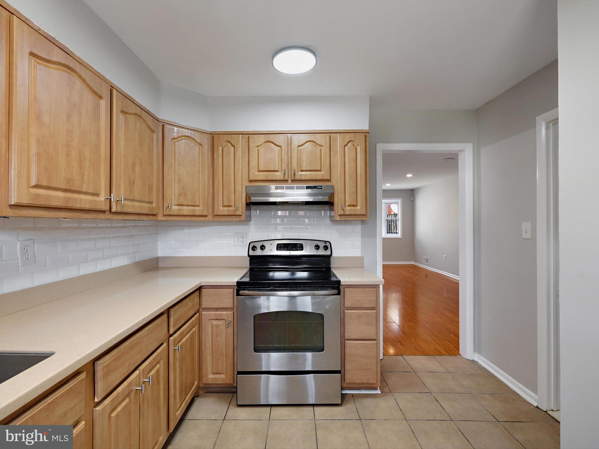 5109 Clacton Avenue, Unit 78 Suitland, MD 20746 - Photo 11 of 33 a kitchen with white cabinets and stainless steel appliances