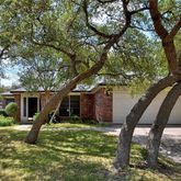 a view of a chair and table in the garden