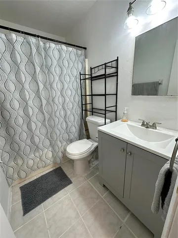 a bedroom with a bed and a chair