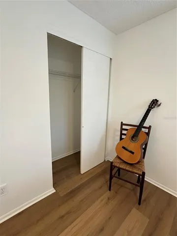 a bedroom with a bed and a chair