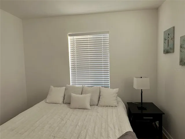 a room with a walk in closet and wooden floor