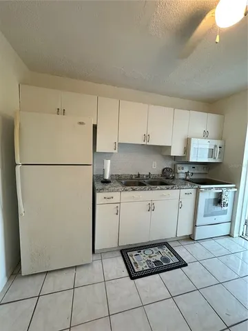 a kitchen with stainless steel appliances a stove a microwave and a sink
