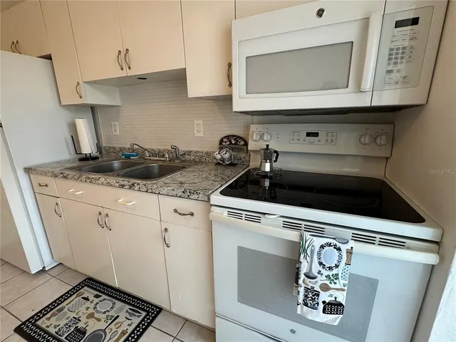 a utility room with cabinets washer and dryer