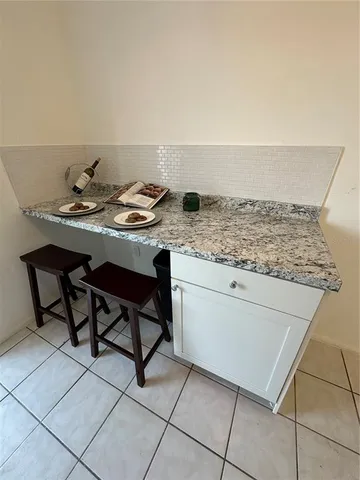 a kitchen with granite countertop a sink and a stove
