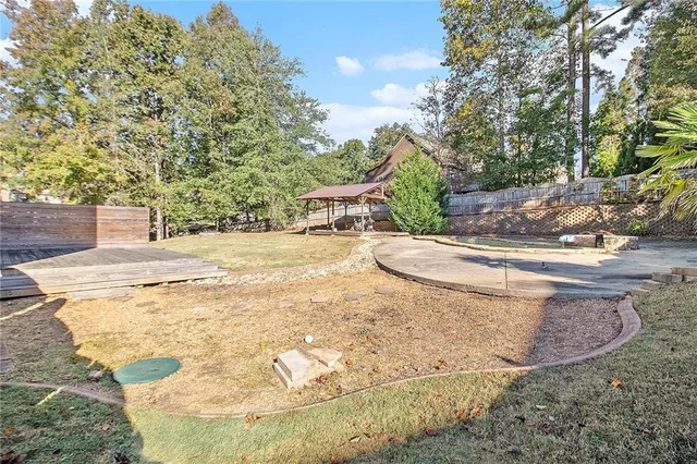 a swimming pool with outdoor seating and yard
