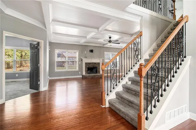 wooden floor fireplace and windows in an empty room