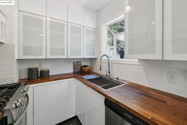a kitchen with a sink stove and cabinets
