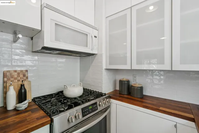 a kitchen with stainless steel appliances granite countertop a sink stove and cabinets