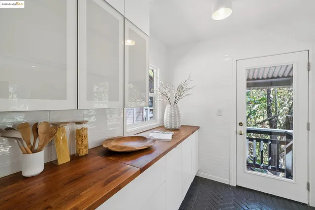 a kitchen with a sink and wooden floor