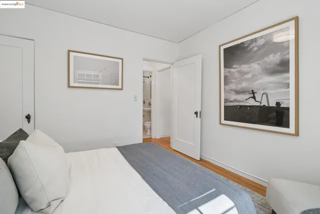 a bedroom with a bed and wall painting