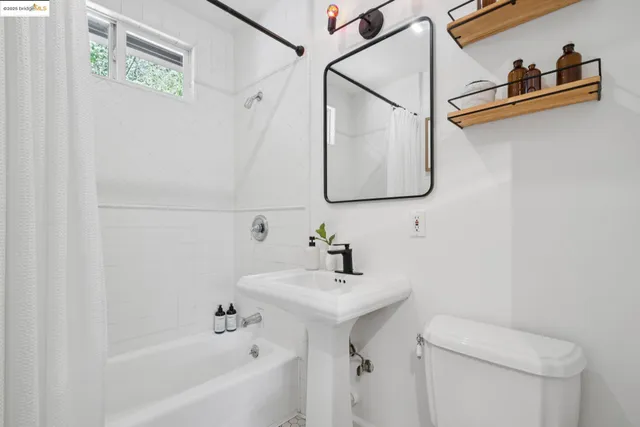 a bathroom with a sink mirror and toilet