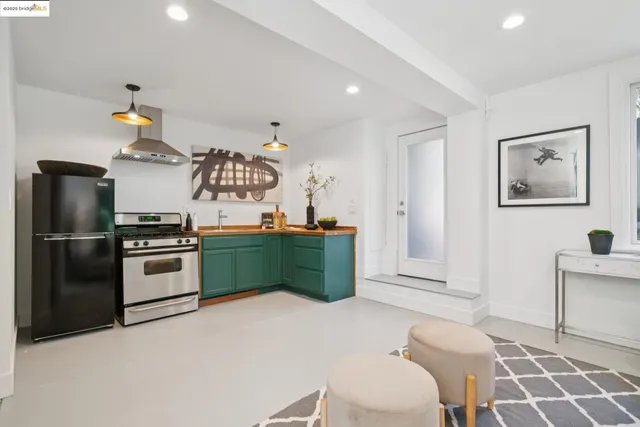 a kitchen with a stove and a refrigerator