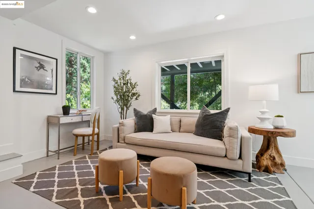 a living room with furniture a window and a table