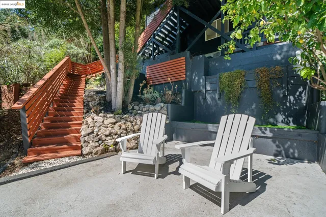 a view of backyard with deck and outdoor seating