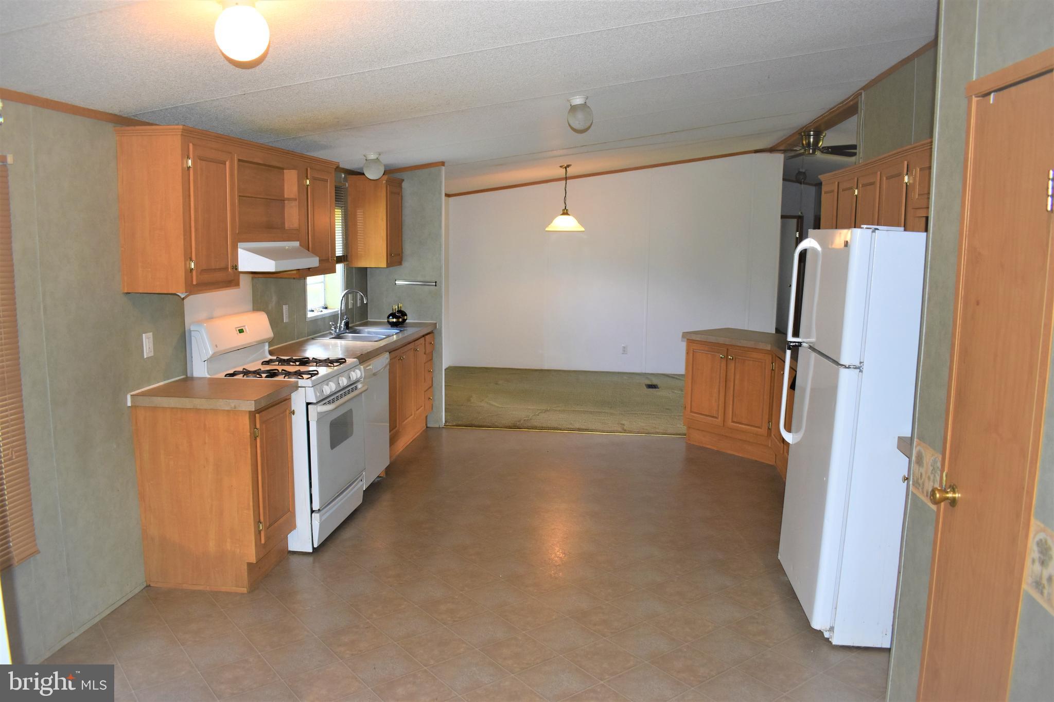 1650 Cypress Branch Road Magnolia, DE 19962 - Photo 18 of 34 a kitchen with a refrigerator a stove a washer and dryer