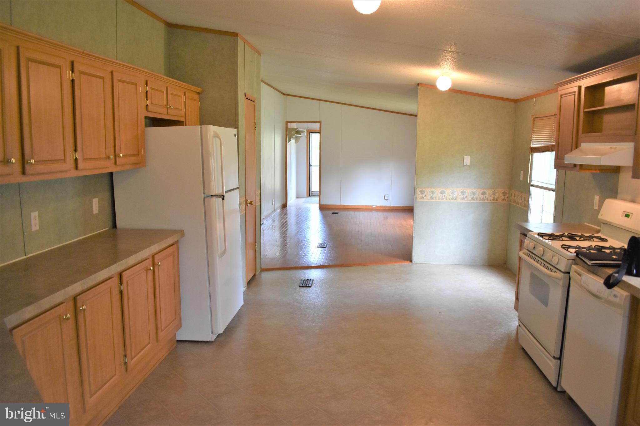 1650 Cypress Branch Road Magnolia, DE 19962 - Photo 19 of 34 a view of a kitchen with a refrigerator and a stove top oven