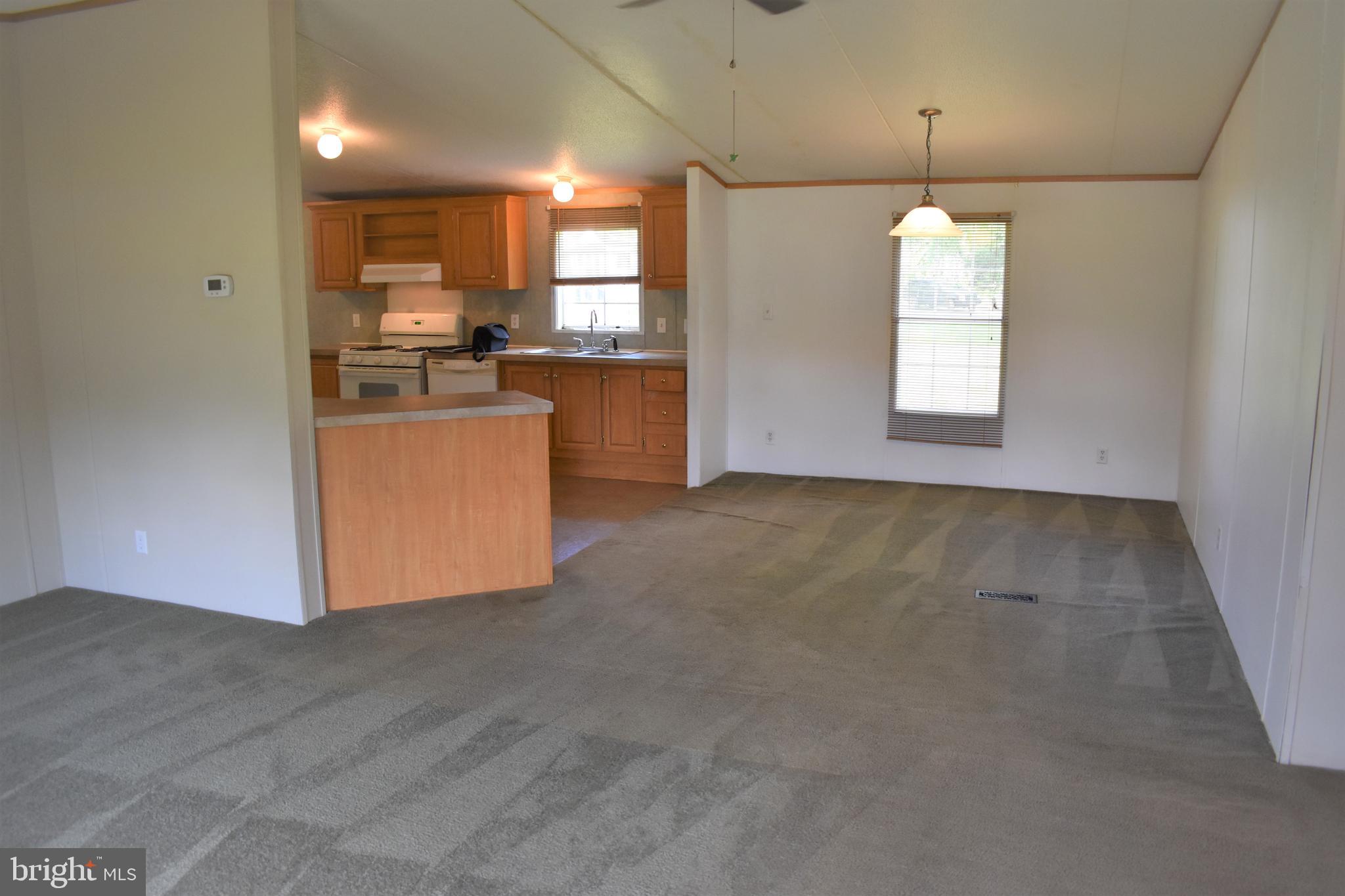 1650 Cypress Branch Road Magnolia, DE 19962 - Photo 26 of 34 an empty room with chandelier fan and windows