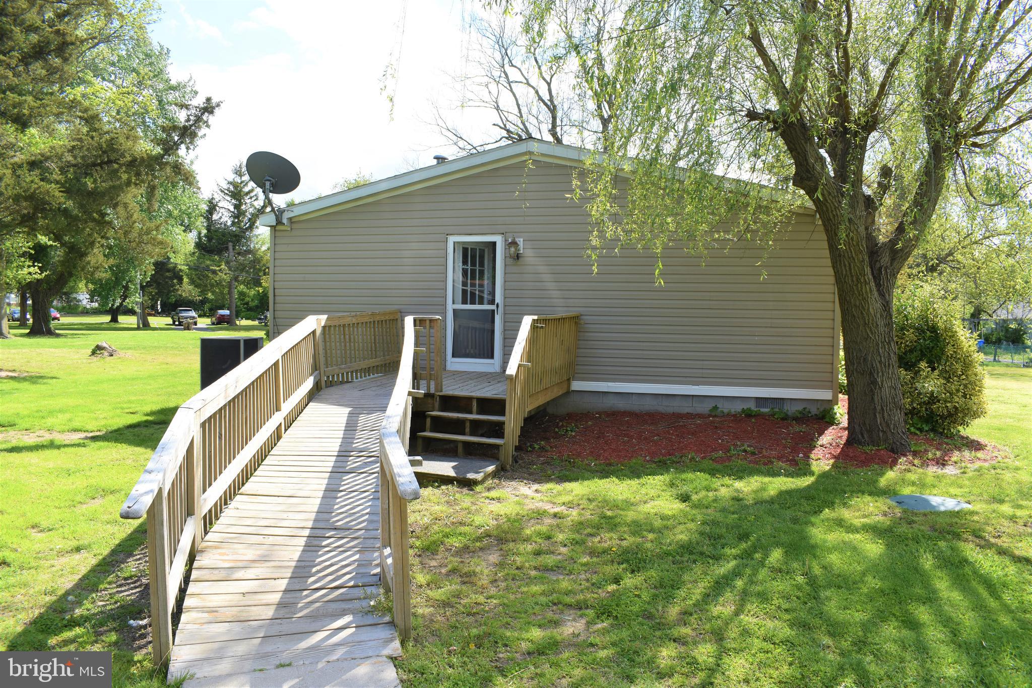 1650 Cypress Branch Road Magnolia, DE 19962 - Photo 5 of 34 a view of a deck with a bench and floor to ceiling window