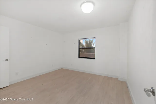 a view of an empty room with a fireplace
