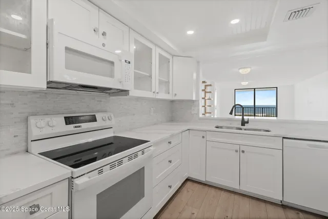 a kitchen with a sink stove and cabinets