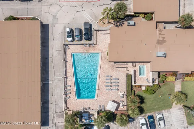 an aerial view of a house with a yard and potted plants