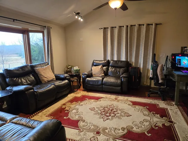 a living room with furniture and a lamp