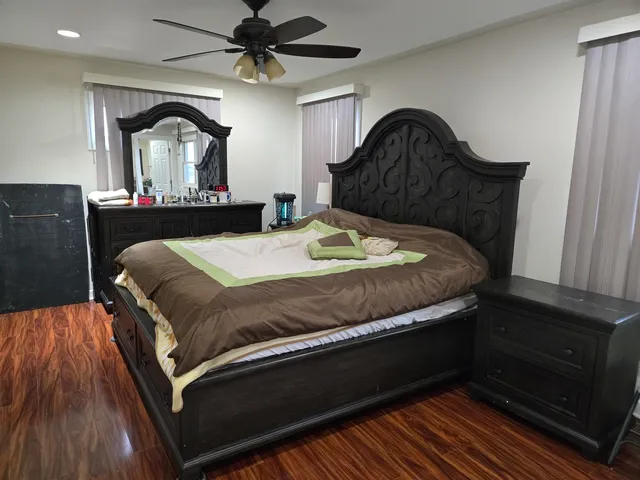 a bed sitting in a bedroom next to a window