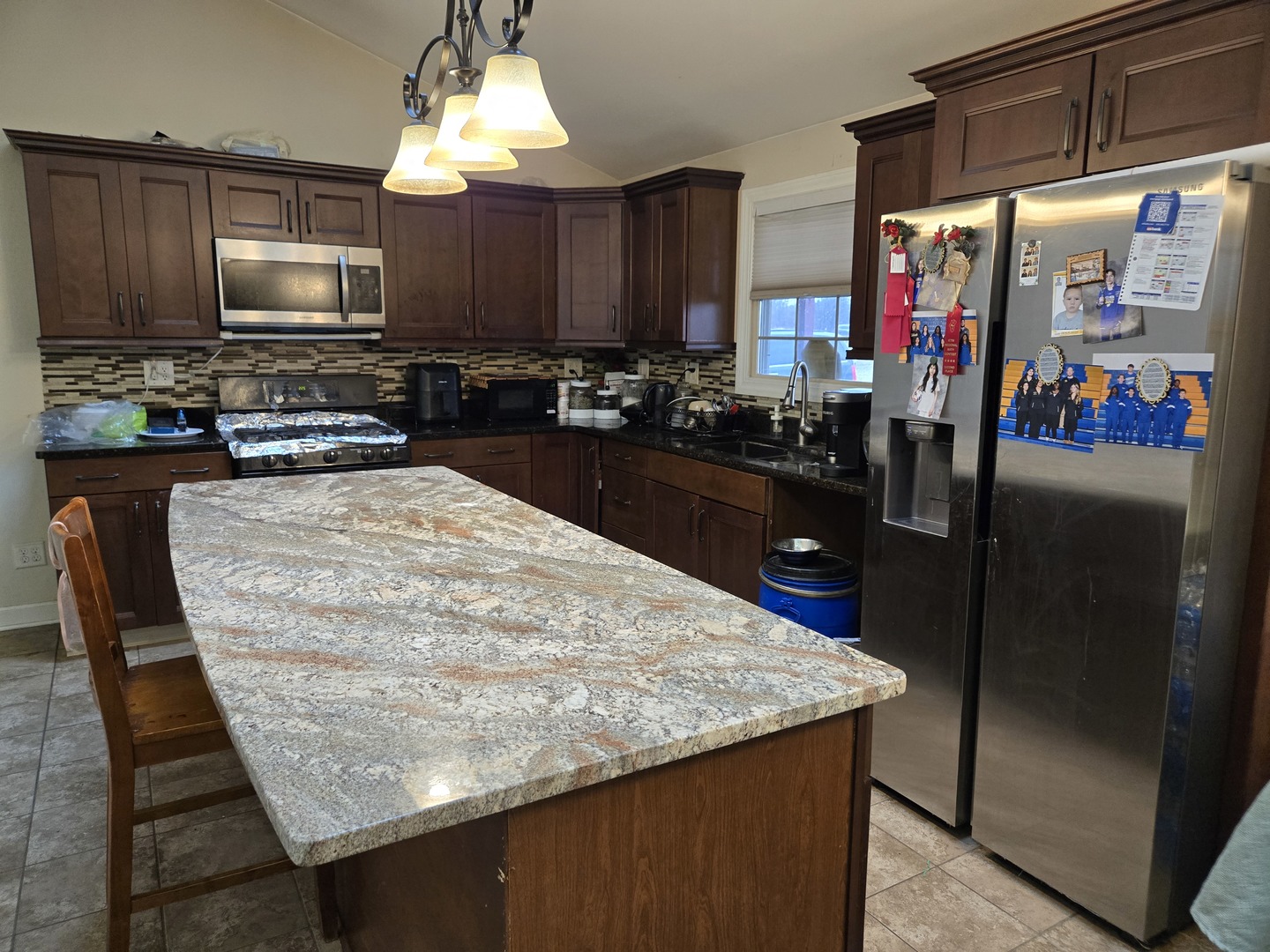 3303 East Exchange Street Crete, IL 60417 - Photo 3 of 38 a kitchen with a stove a sink and a refrigerator