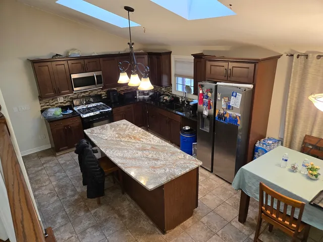 a kitchen with a refrigerator a stove and a sink