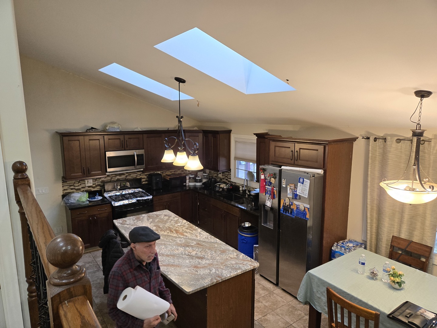 3303 East Exchange Street Crete, IL 60417 - Photo 5 of 38 a kitchen with a table chairs and flat screen tv