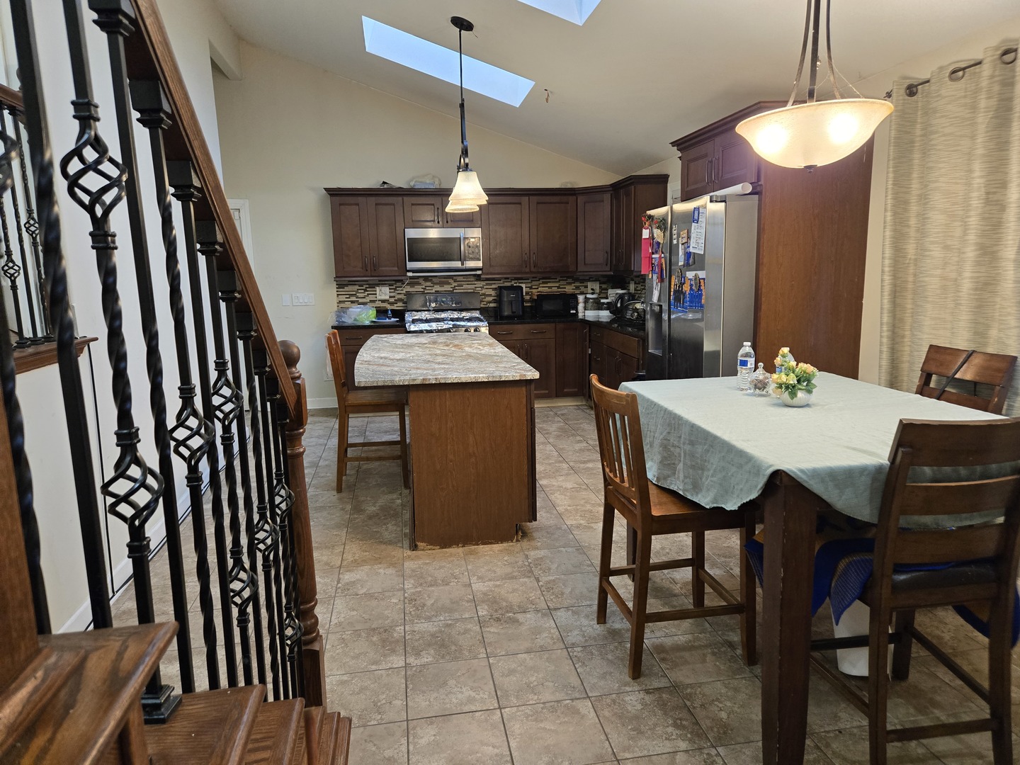 3303 East Exchange Street Crete, IL 60417 - Photo 7 of 38 a kitchen with a dining table chairs and white cabinets