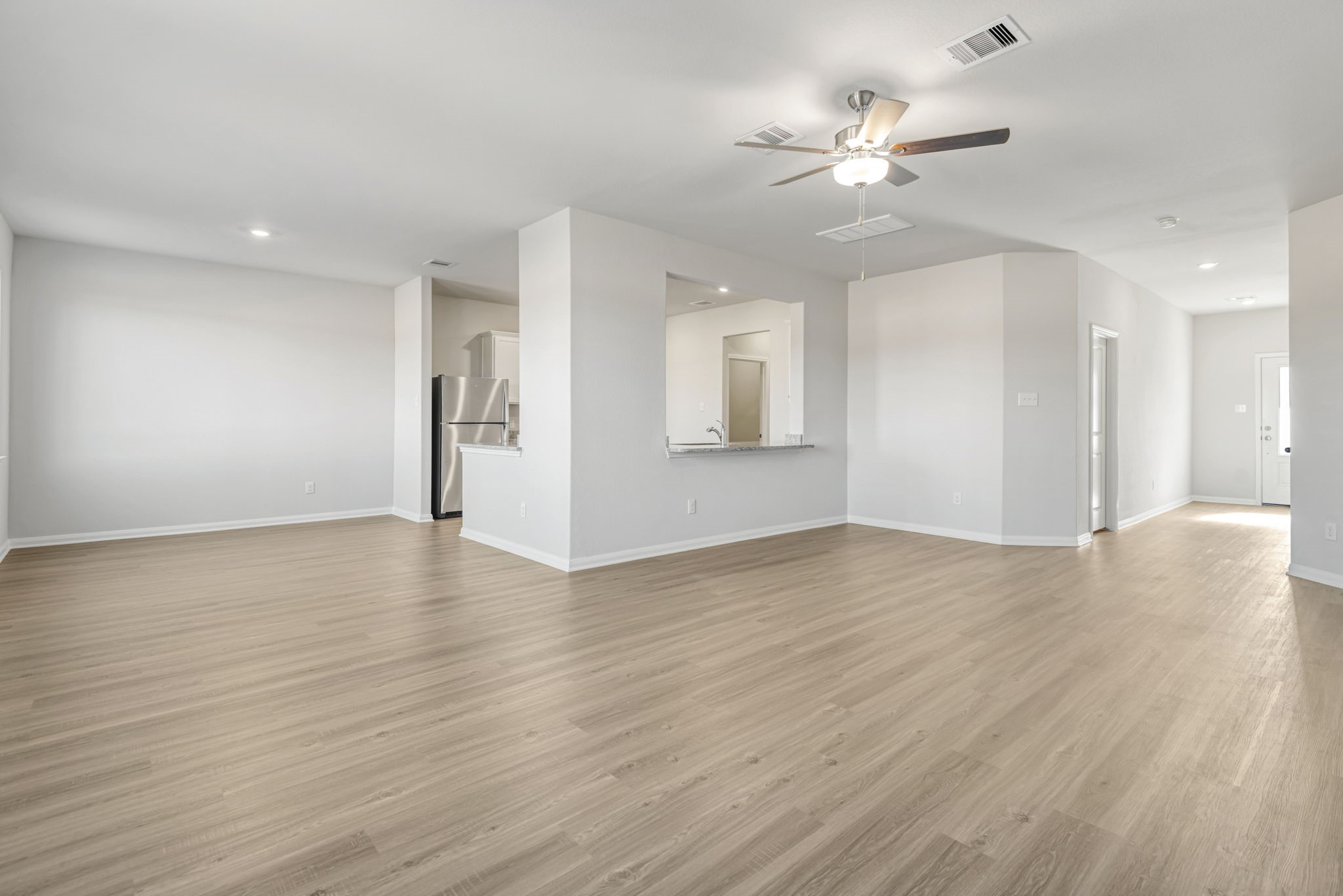 6416 Winter Elm Street Houston, TX 77048 - Photo 2 of 8 a view of an empty room with wooden floor and a ceiling fan