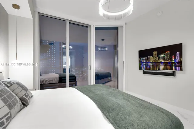 a view of a workspace with furniture and a floor to ceiling window